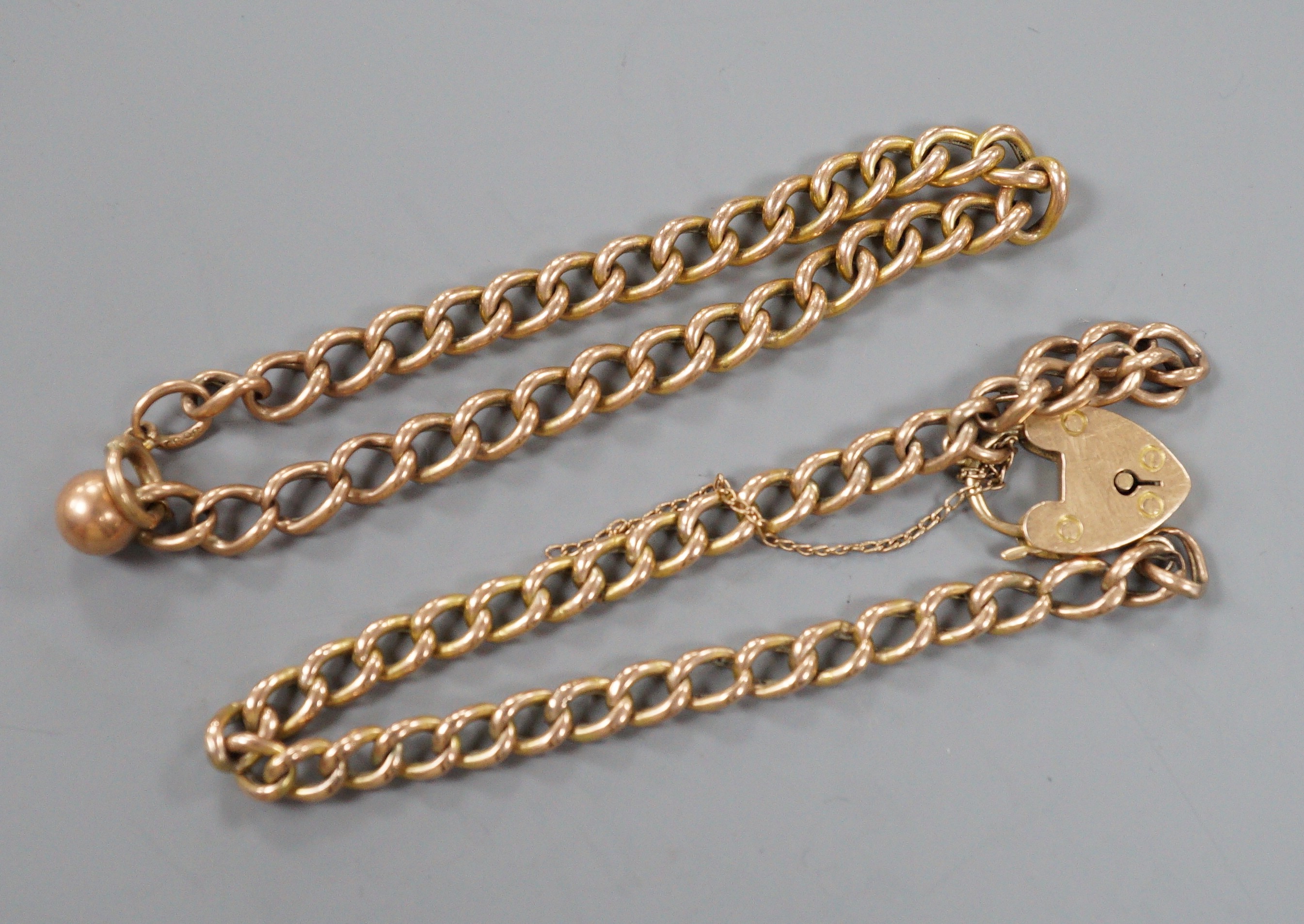 A 9ct curb link bracelet and a yellow metal curb link bracelet with 15ct clasp, gross weight 10.1 grams.